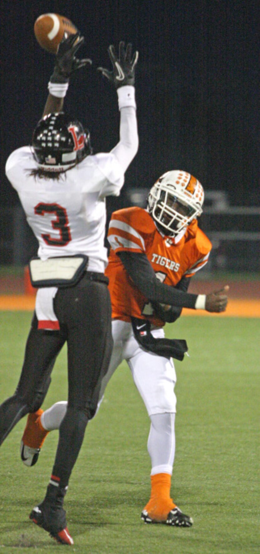 Lancaster senior quarterback Demarcus Ayers (1) has his pass attempt tipped by Mansfield...