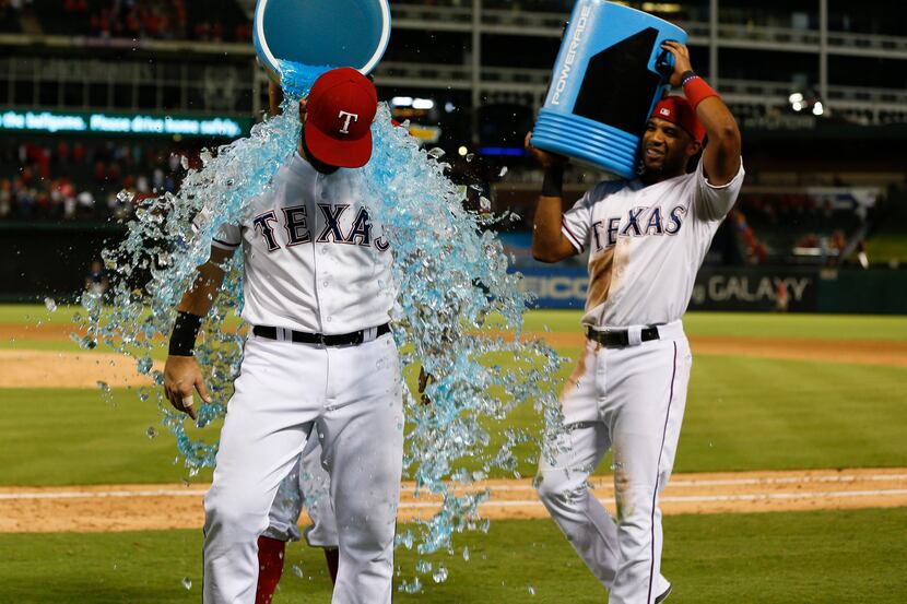 Sep 17, 2015; Arlington, TX, USA; Texas Rangers first baseman Mitch Moreland (18) is doused...