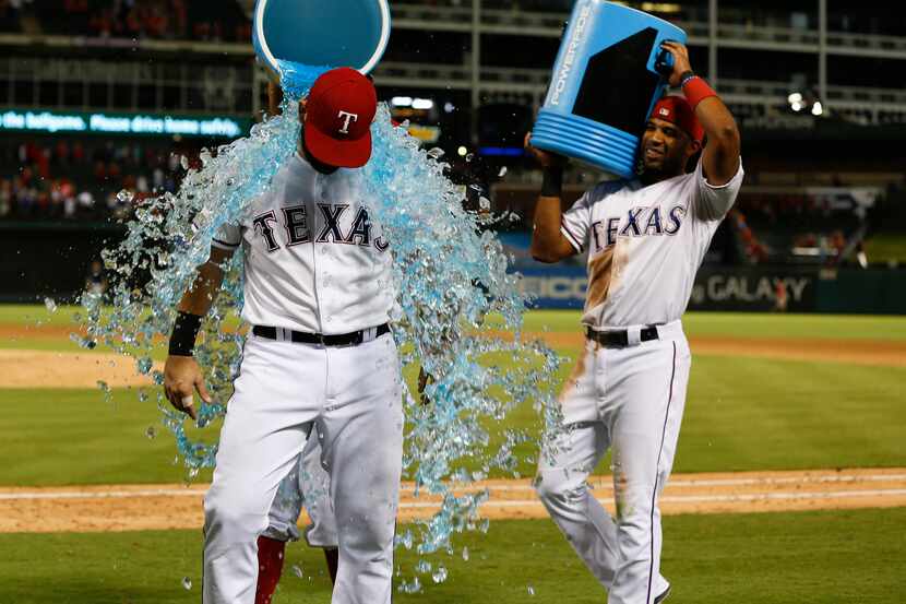 Sep 17, 2015; Arlington, TX, USA; Texas Rangers first baseman Mitch Moreland (18) is doused...