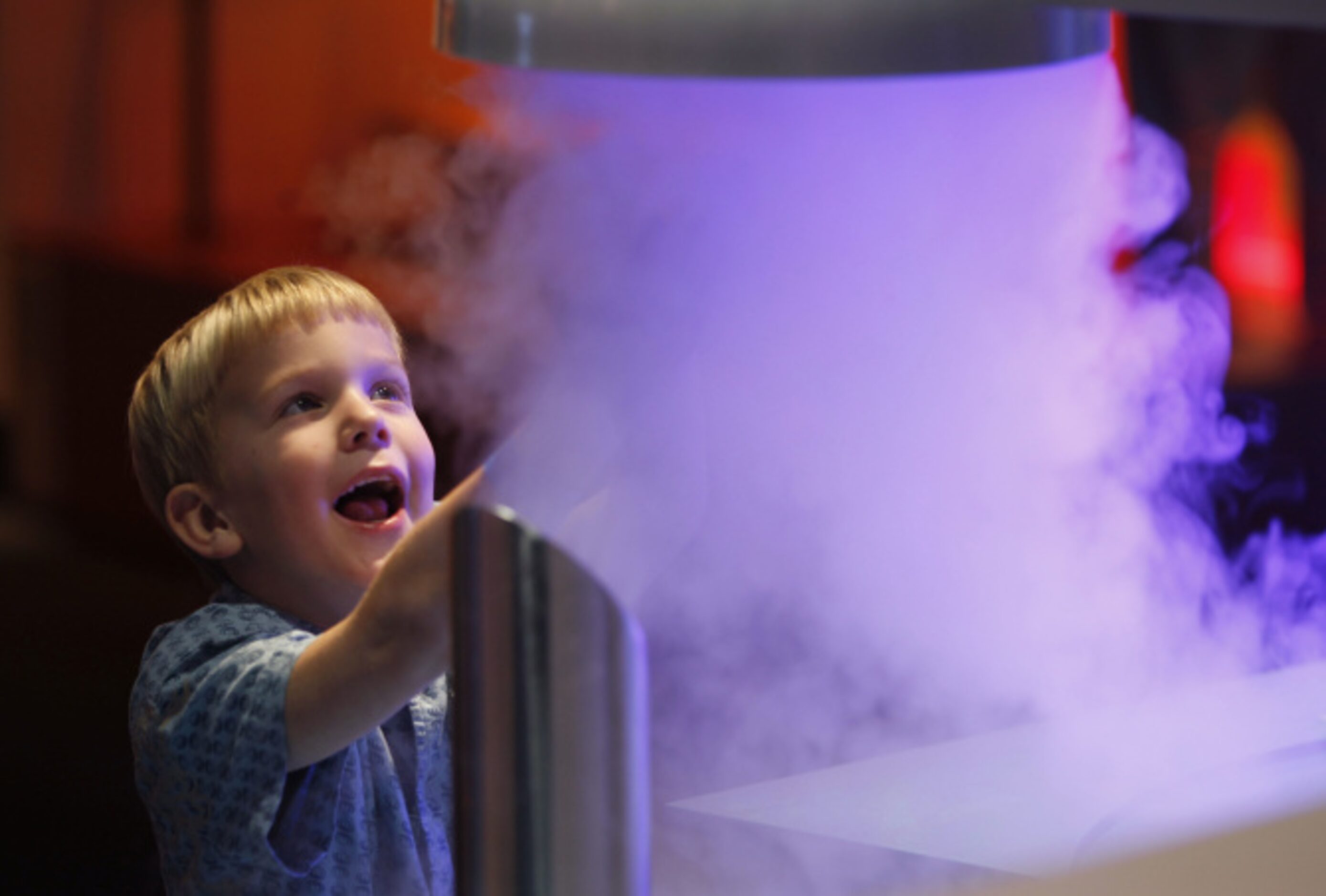 William Hardaway, 5 of Dallas, plays with a cloud in the water cycle exhibit during the...