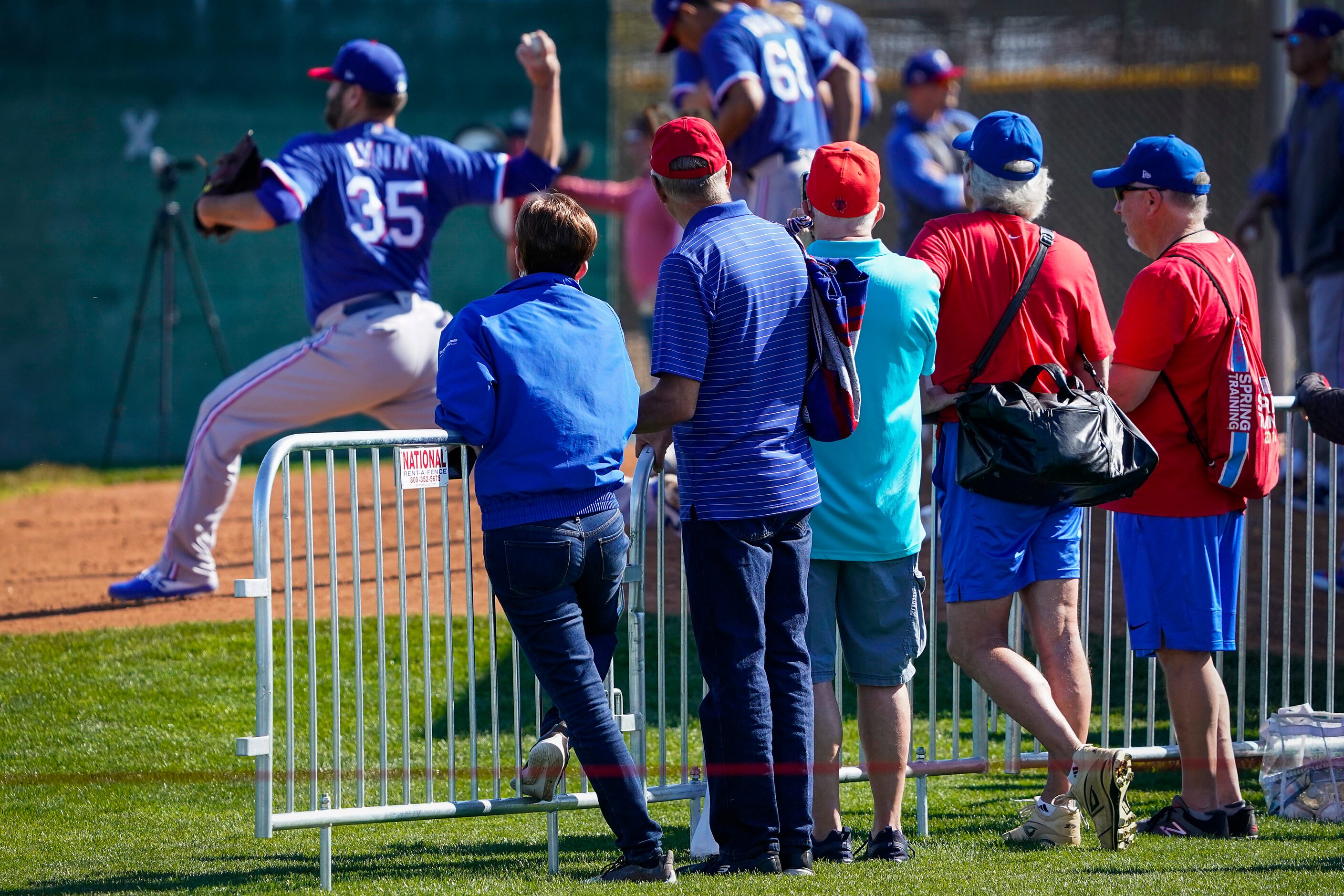 Fans watch as pitchers, including Lance Lynn (35), throw in the bullpen during a spring...