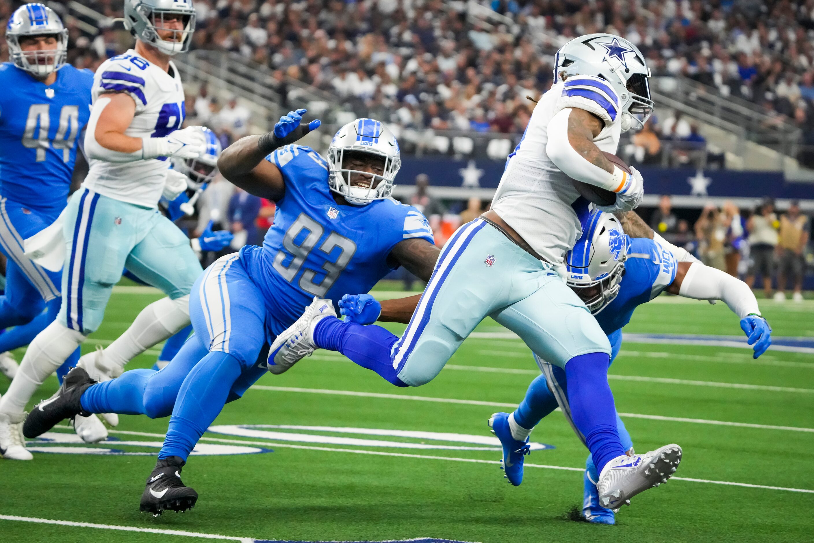 Dallas Cowboys running back Ezekiel Elliott (21) is brought down by Detroit Lions cornerback...