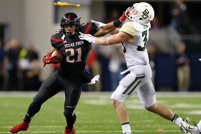 Texas Tech Red Raiders running back DeAndre Washington (21) gives Baylor Bears safety Collin...