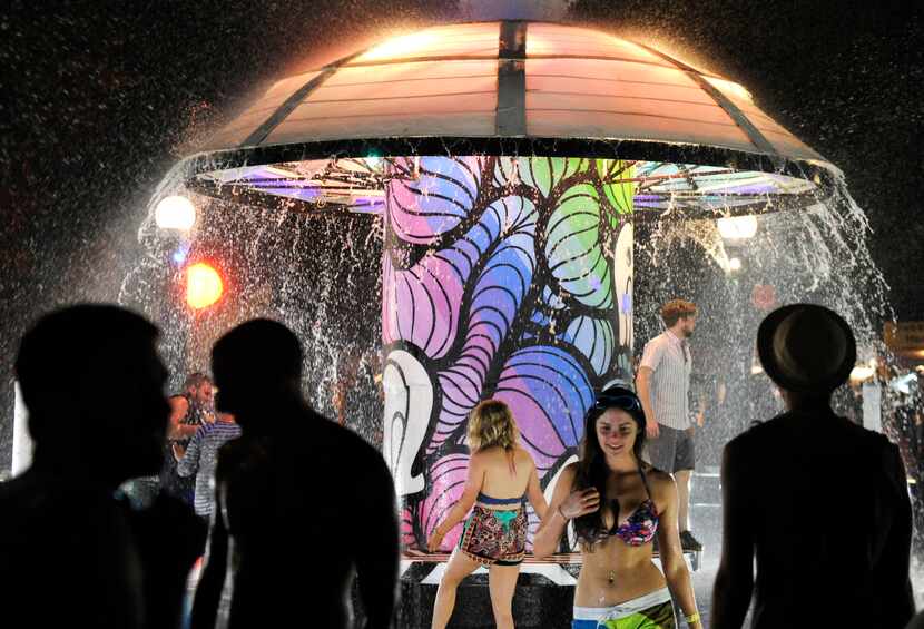 Festival-goers gather at the Fountain during the Bonnaroo Music & Arts Festival Thursday,...
