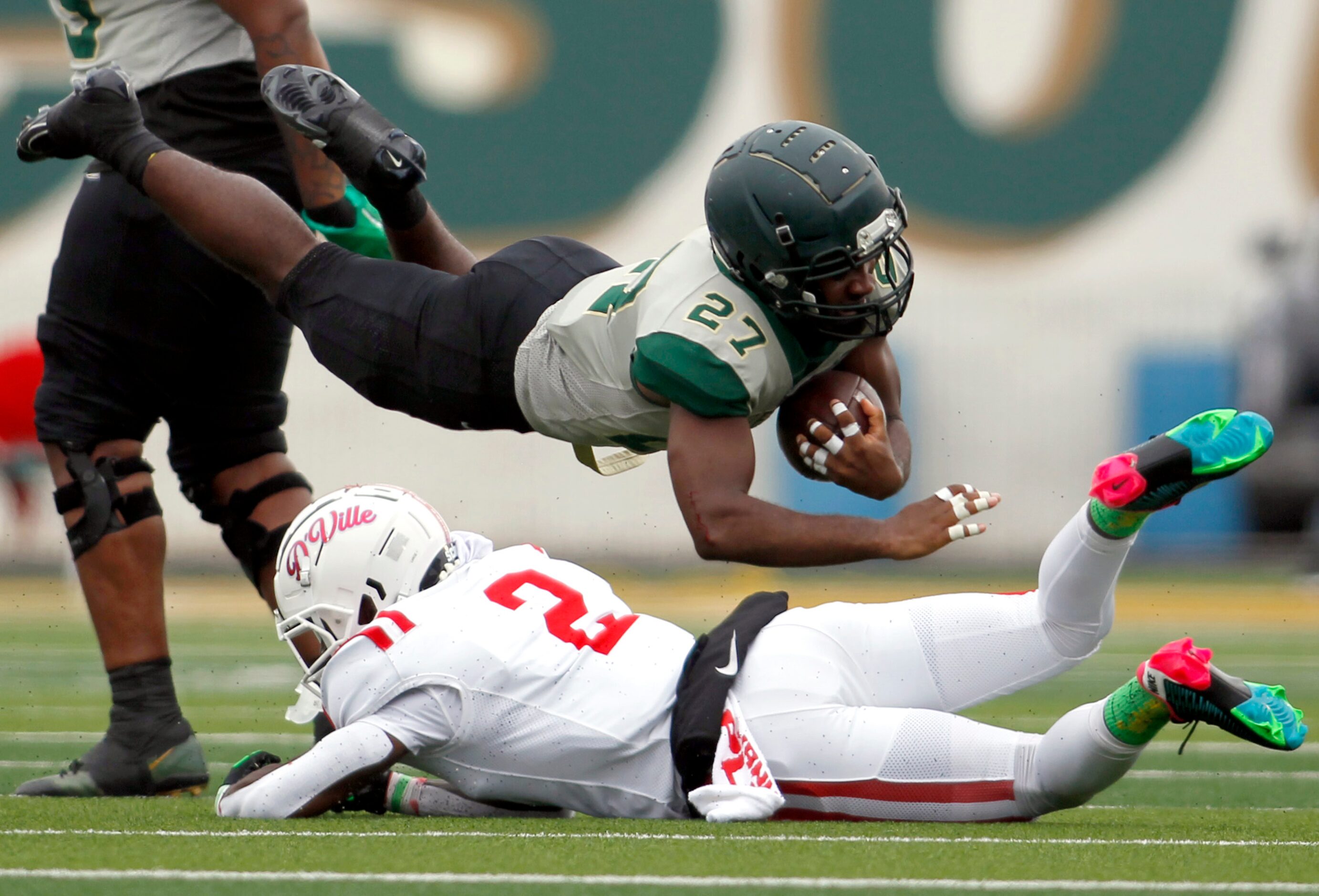 DeSoto running back Marvin Duffy (27) dives over Duncanville defensive back Kadavion...