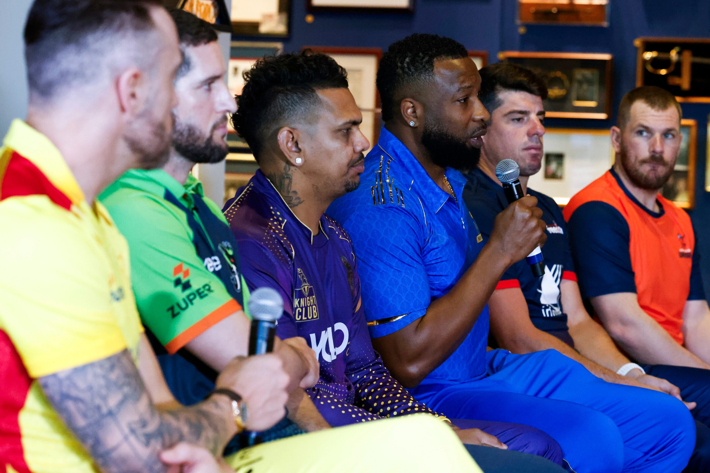 Captains listen to MI New York’s captain Kieron Pollard (center) during a press conference...