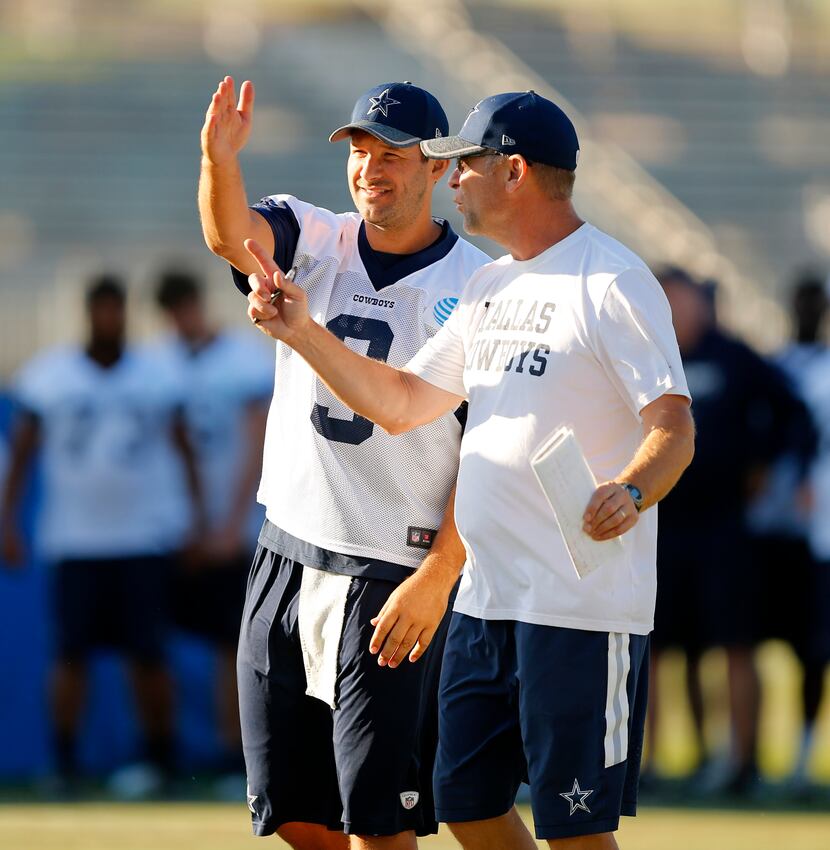 Dallas Cowboys quarterback Tony Romo (9) and offensive coordinator Scott Linehan talk about...