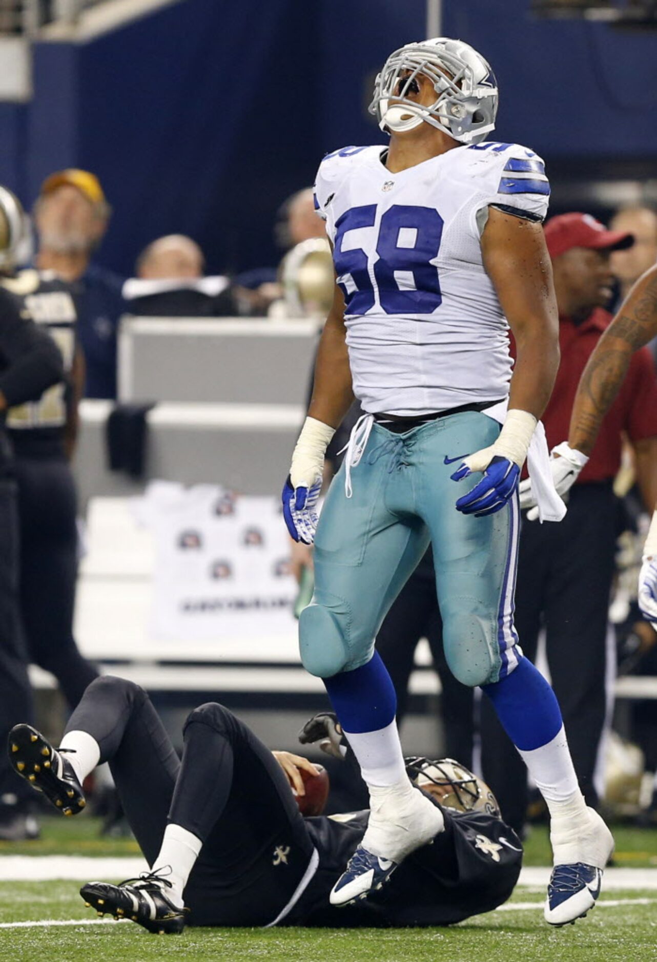 Dallas Cowboys defensive end Jack Crawford (58) celebrates his tackle of New Orleans Saints...