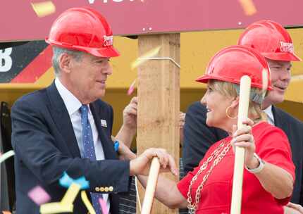 Steven Tanger, CEO and president of Tanger Outlets and  Fort Worth mayor Betsy Price, shake...