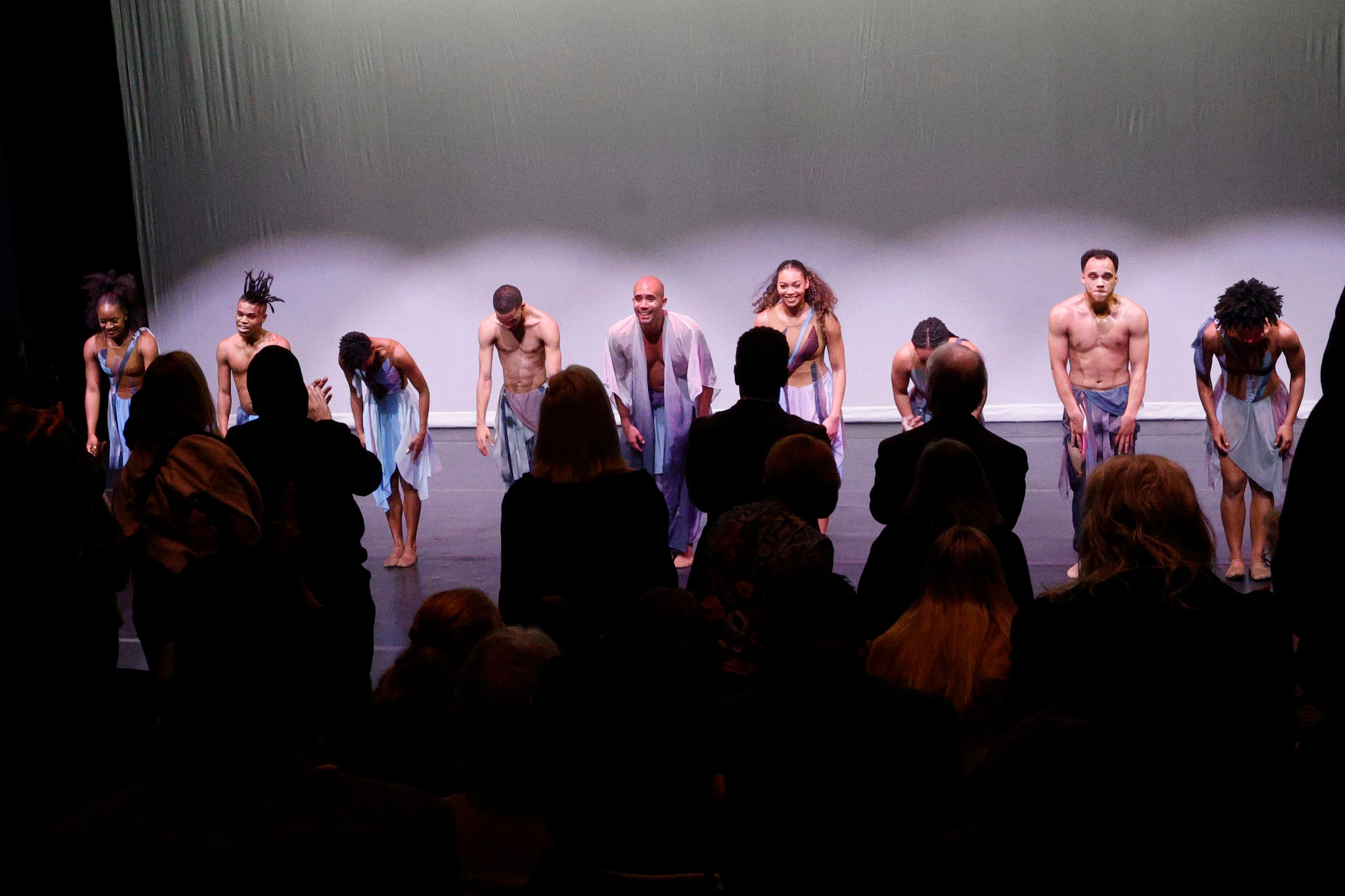 Former Dallas Black Dance Theatre dancers take a bow after performing “ When the Wind...