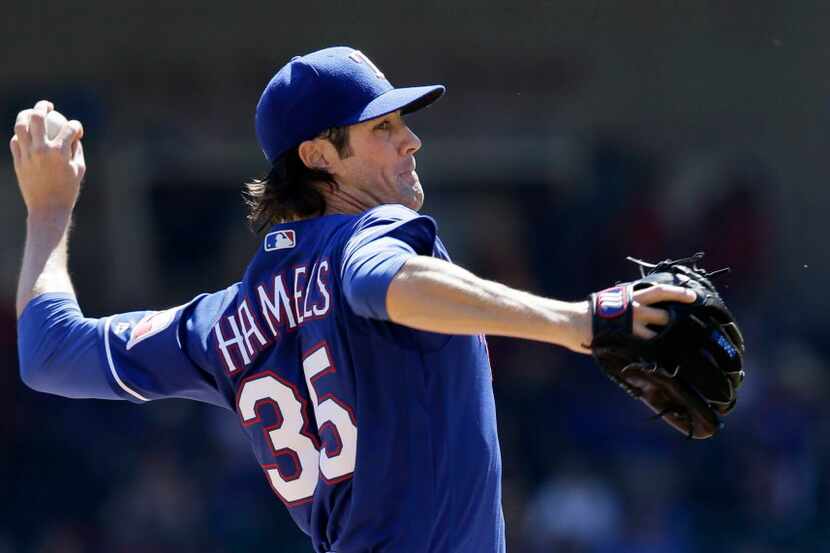 Texas Rangers starting pitcher Cole Hamels throws during the first inning of a baseball game...