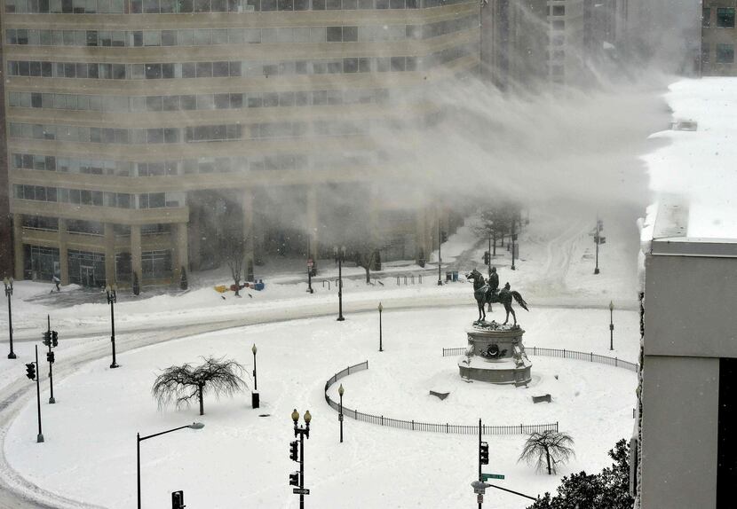  Strong wind blows snow from the roof of a building in Washington on January 23, 2016....