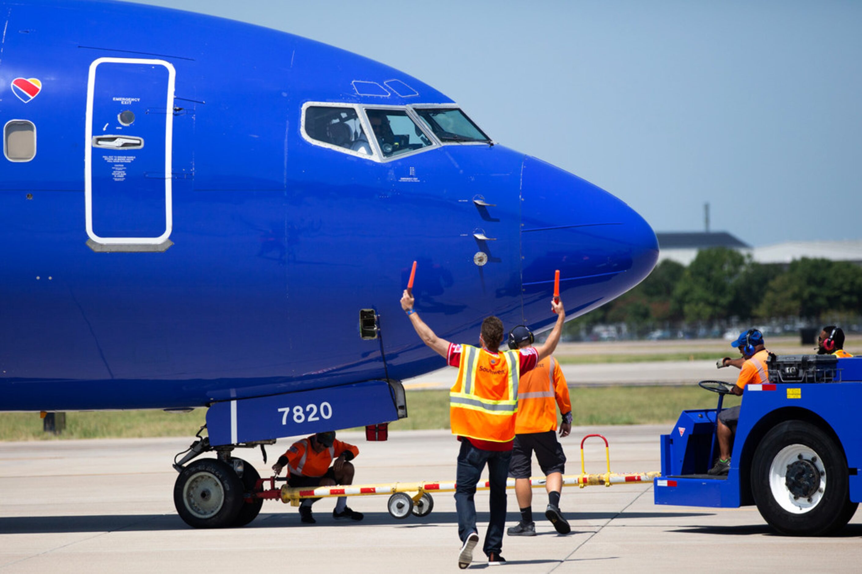 Texas Rangers right fielder Hunter Pence (center) assists aircraft marshallers as center...