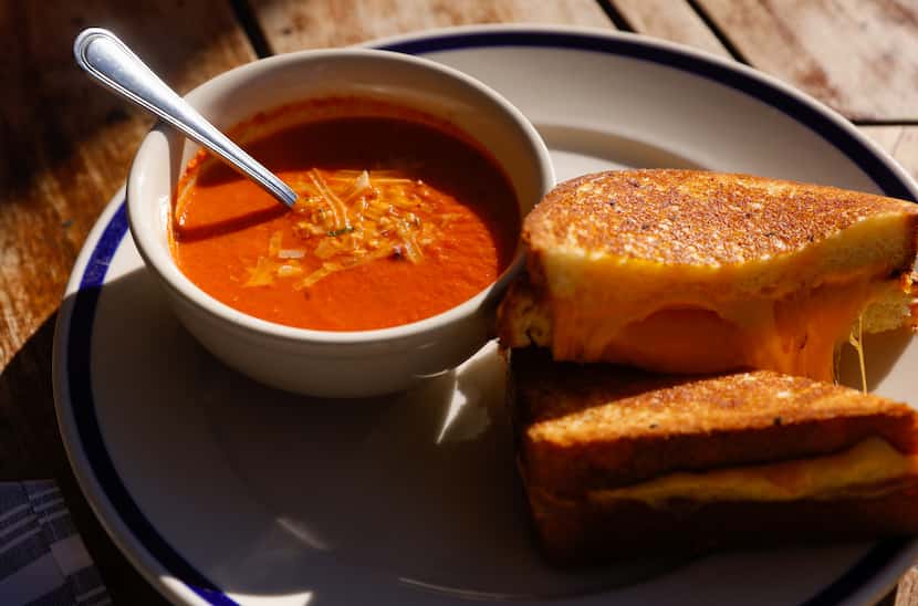 The Porch's three-cheese grilled cheese with a side of roasted tomato soup is a popular...