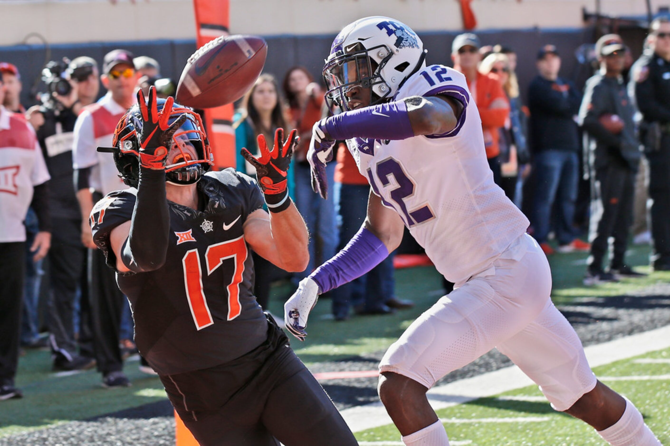 Oklahoma State wide receiver Dillon Stoner (17) catches a pass for a touchdown in front of...