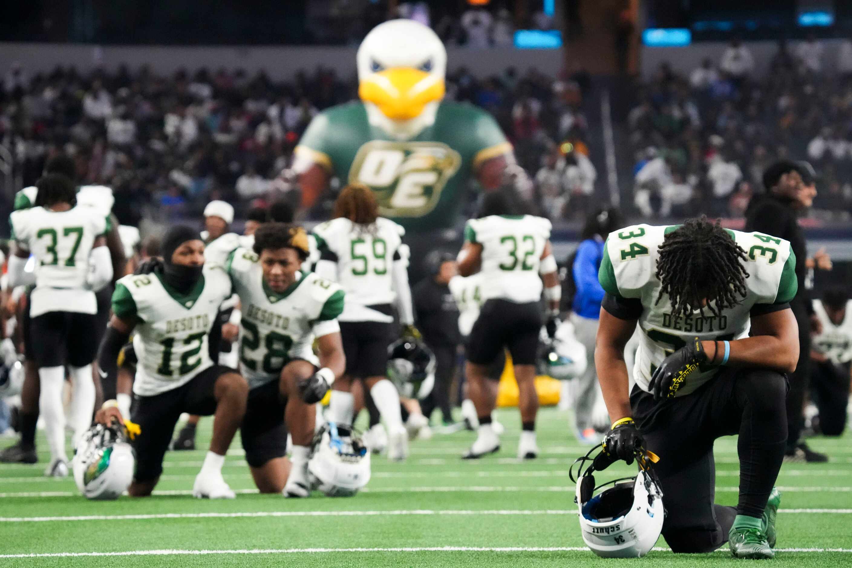 DeSoto Nicholas Hamilton kneels in prayer before the Class 6A Division II state championship...