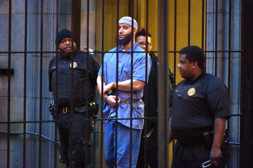 Officials escort "Serial" podcast subject Adnan Syed from the courthouse following the...