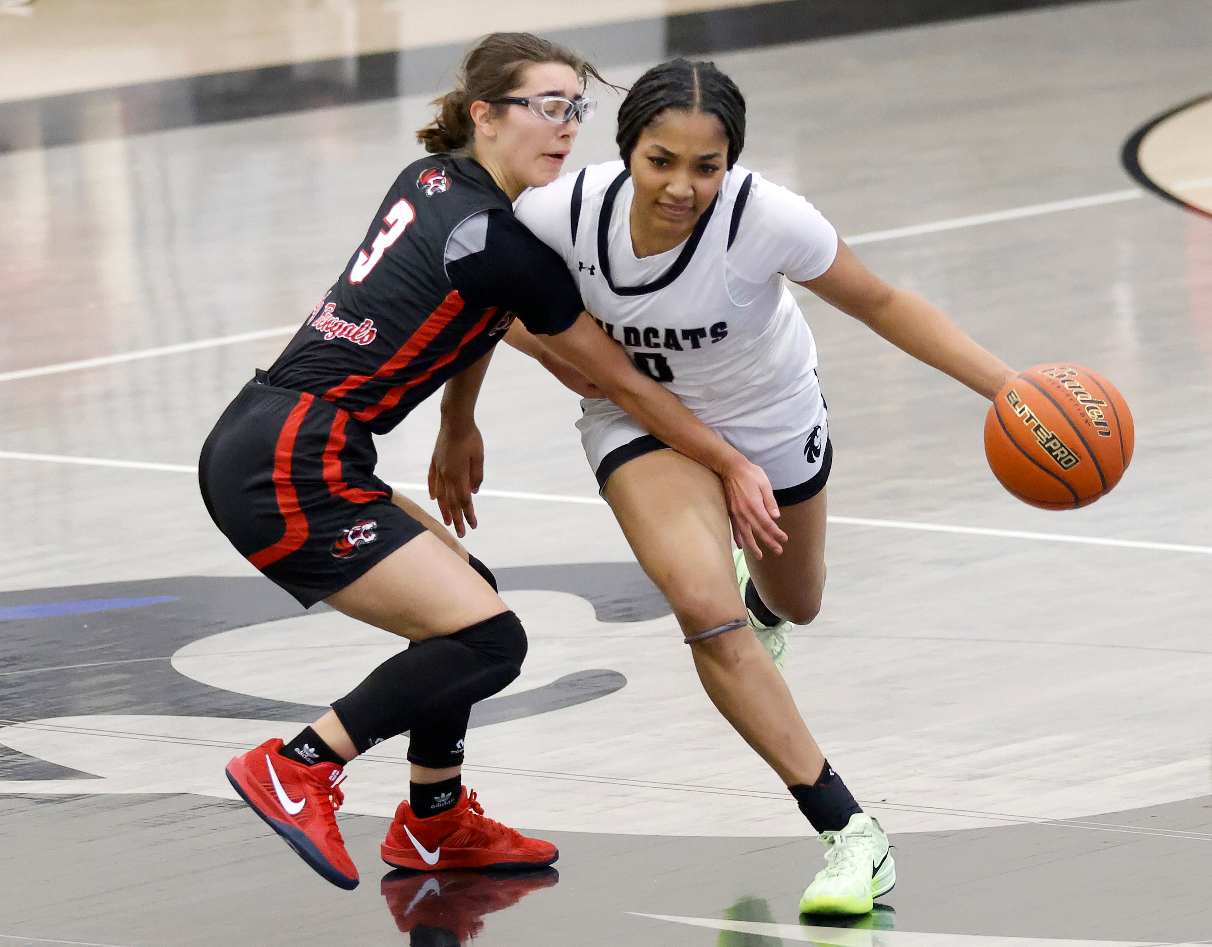 Denton Guyer guard Destanie Green (0) dribbles past Denton Braswell point guard Elayne Gomez...