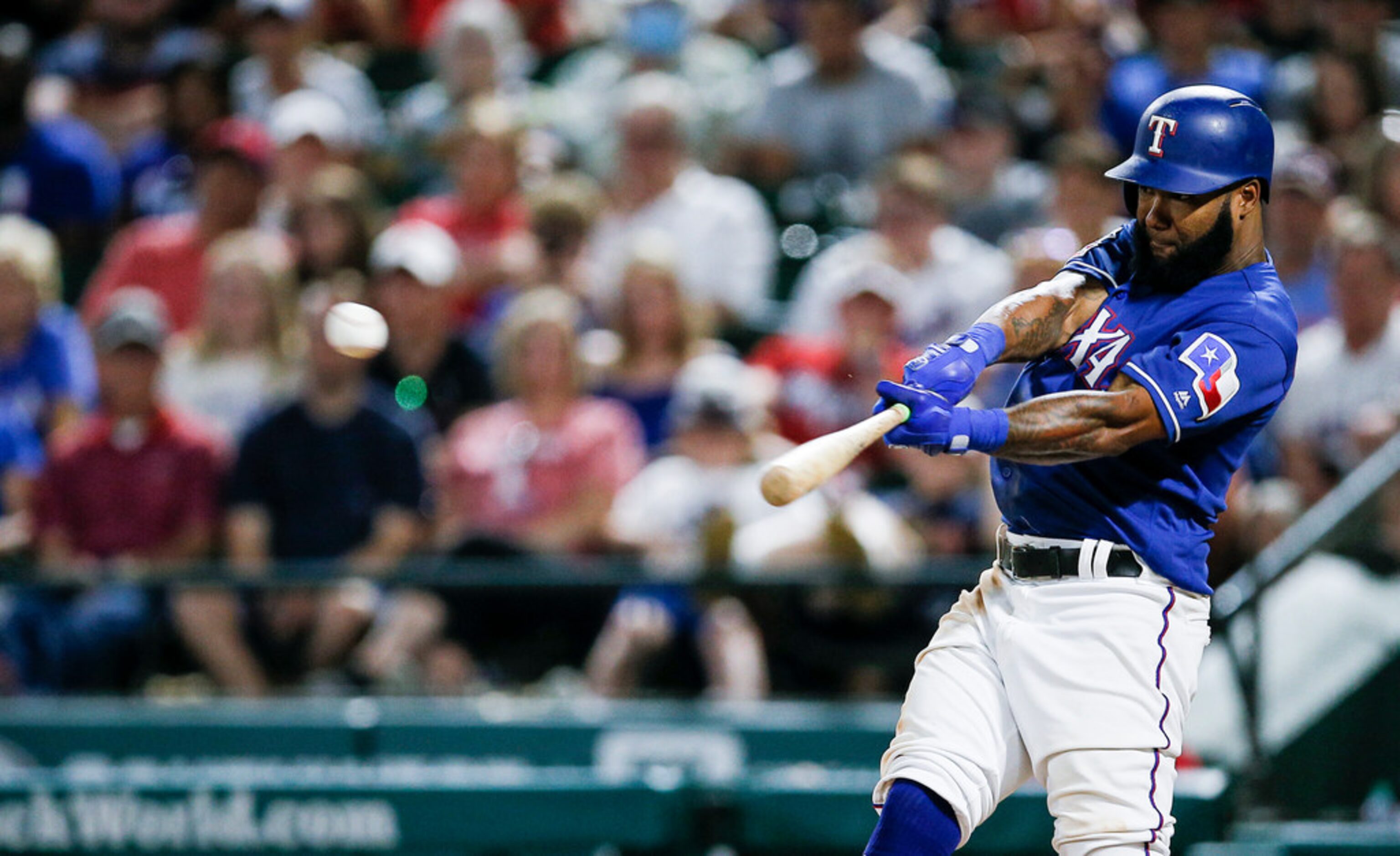 Texas Rangers' Danny Santana makes contact for a walkoff single during the ninth inning of a...