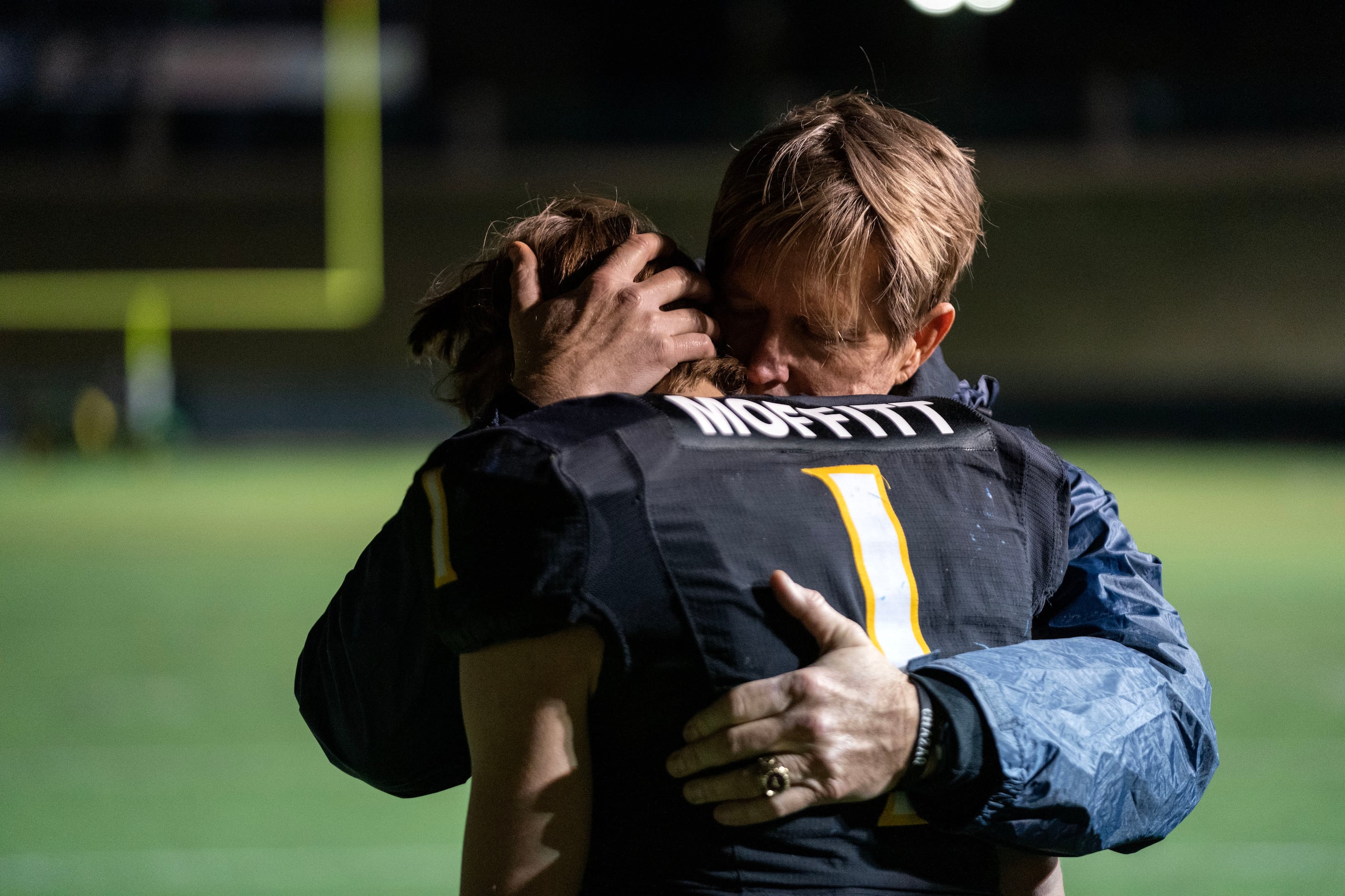 Crandall senior quarterback Luke Moffitt (1) is comforted by his father Marc Moffitt after...