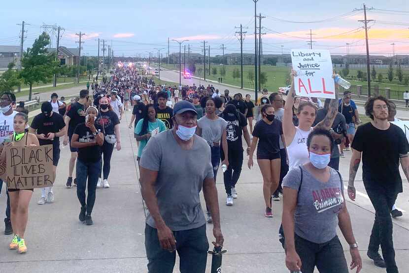 Some of the protesters who marched several miles on Eldorado Parkway in Frisco Monday.