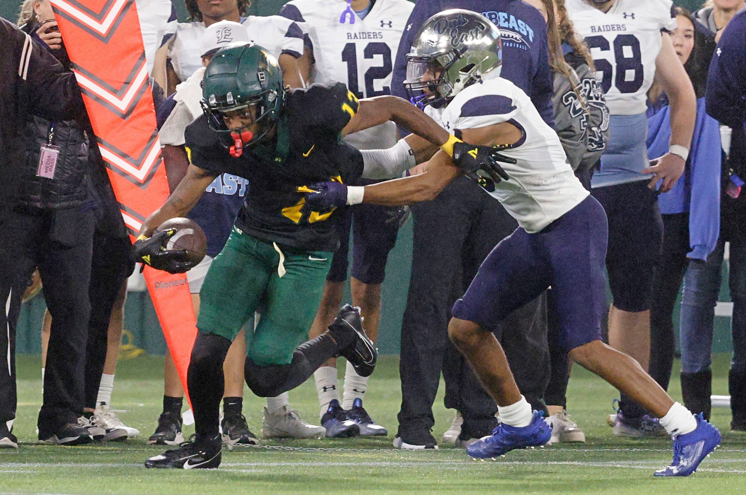 DeSoto's Daylon Singleton (13) carries the ball as Wylie East's Rome Jeffers (5) tries to...