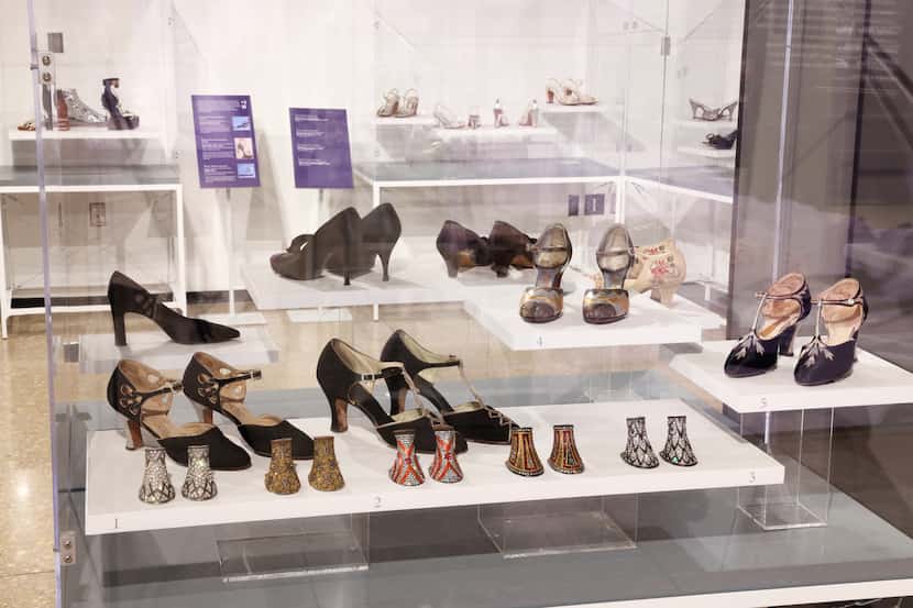 Glass display case containing several pairs of vintage shoes and interchangeable rhinestone...