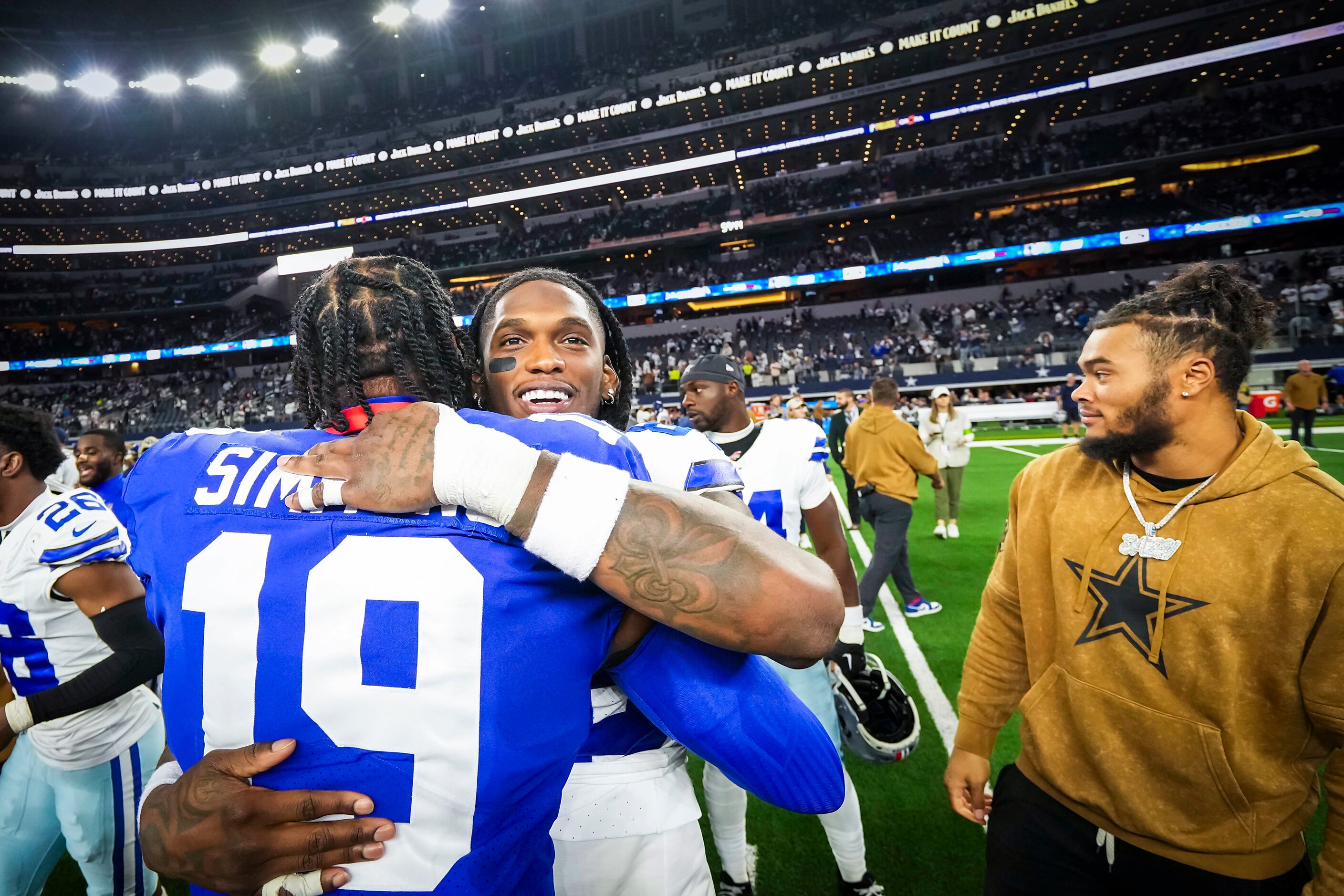 Dallas Cowboys wide receiver CeeDee Lamb (88) hugs New York Giants safety Isaiah Simmons...