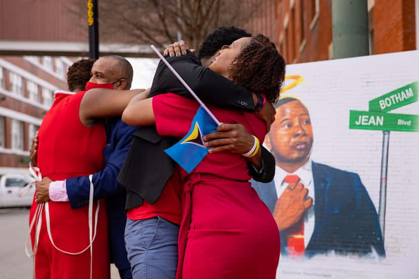 The family of Botham Jean hug after unveiling the street sign for Botham Jean Boulevard...