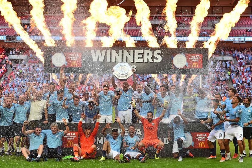 Manchester City's Belgian defender Vincent Kompany lifts up the FA Community Shield as...