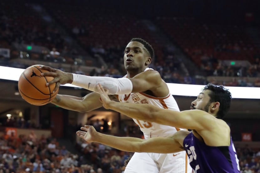 Texas guard Jase Febres (13) and TCU guard Alex Robinson (25) battle for a rebound during...