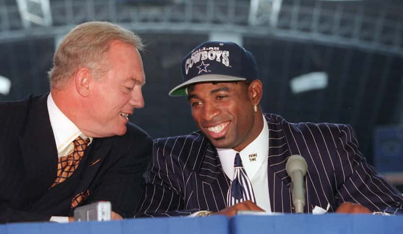  Shot 9-11-95 - Deion Sanders, (R), is all smiles as he talks to Jerry Jones during a press...
