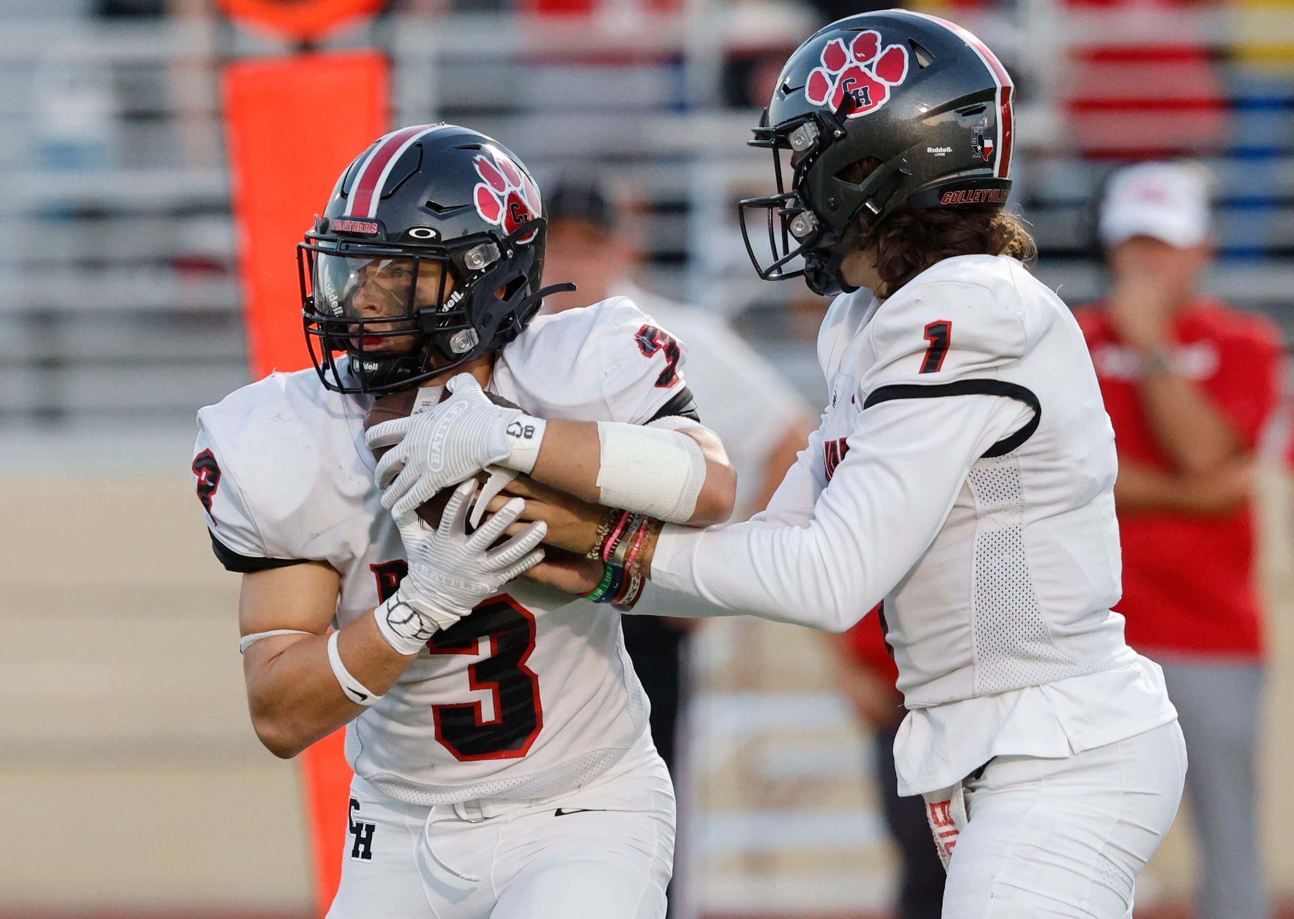 Colleyville Heritage's quarterback Luke Ullrich (1) hands off to Colleyville Heritage's Ryan...