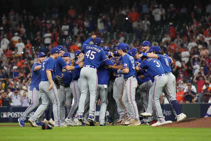 Texas Rangers celebrate by the mound after defeating the Houston Astros in Game 7 of the...