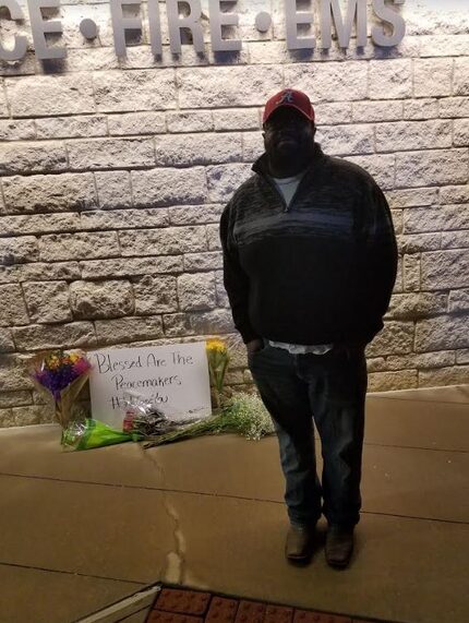 Michael King, a former Little Elm High School student, stands in front of a memorial for...