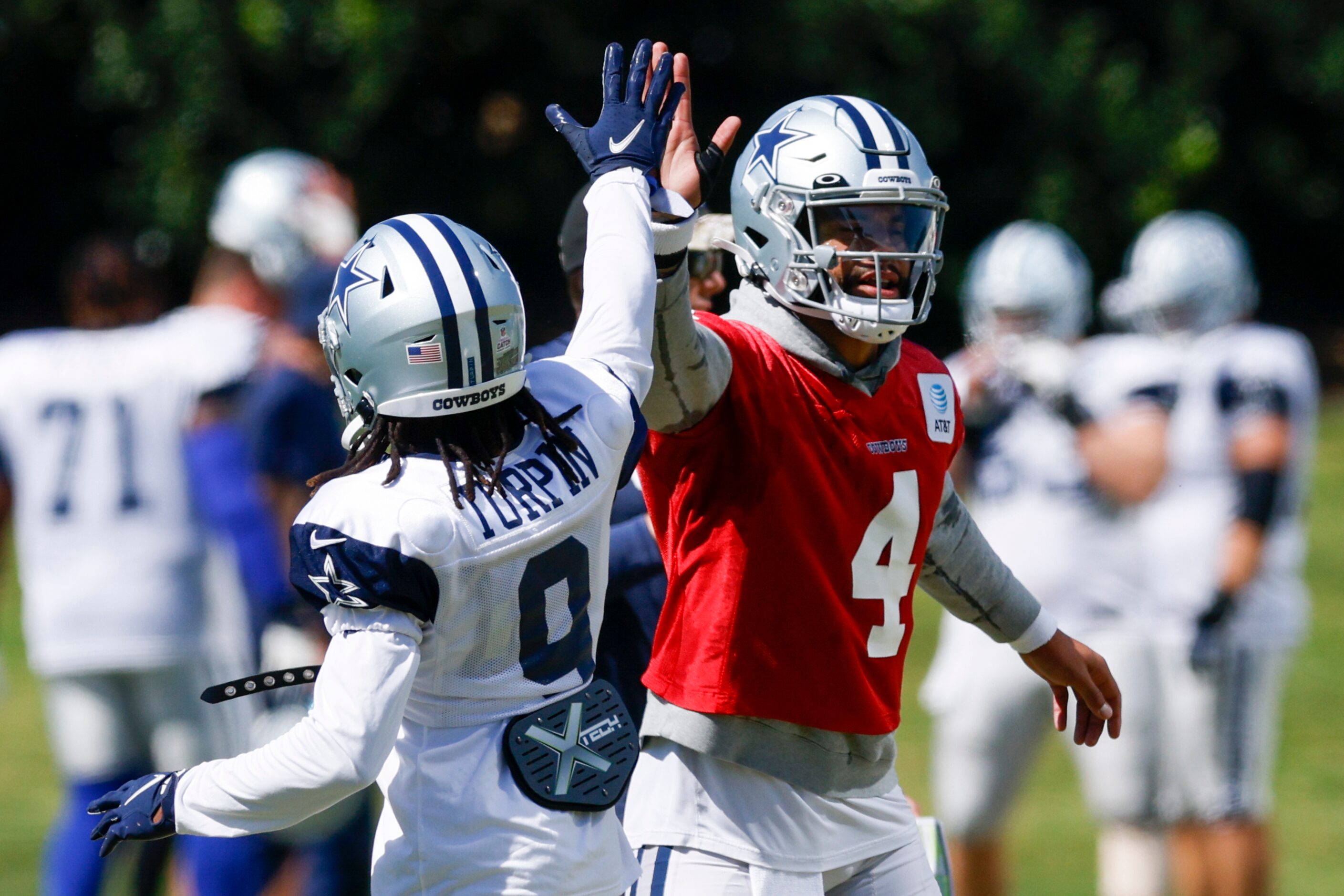 Dallas Cowboys quarterback Dak Prescott (4) high-fives wide receiver KaVontae Turpin (9)...