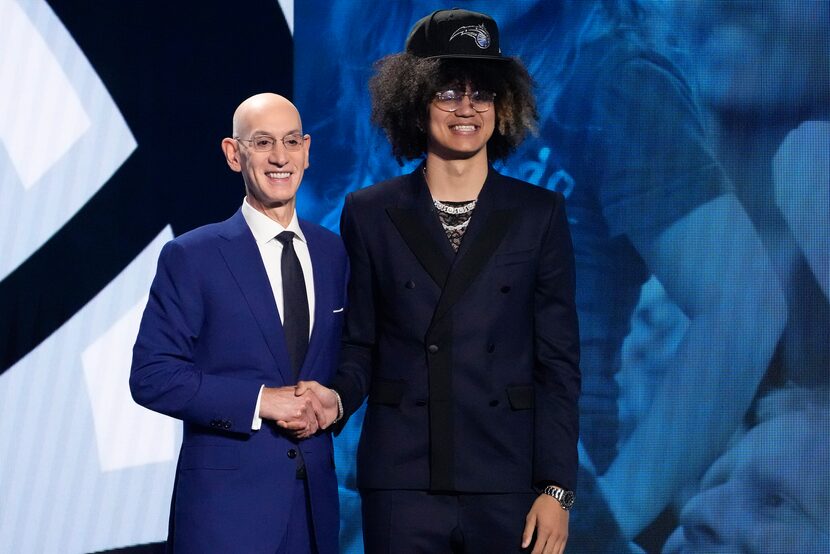 Anthony Black, right, poses with NBA Commissioner Adam Silver after being selected sixth...