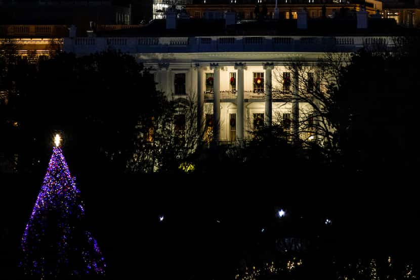 A general view of the White House on Saturday, Dec. 26, 2020, as night falls in Washington,...