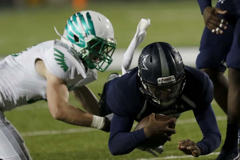 Lake Dallas Falcons Jacob Peppard (left) attempts to tackle Frisco Lone Star Rangers QB...