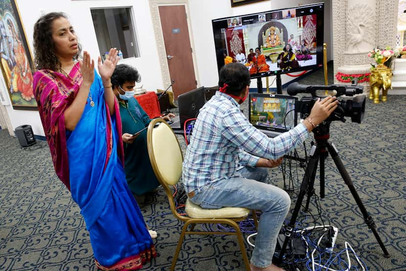 Temple president Shreya Bhat sings along as a live broadcast of Bhoomi Poojan, a three-day...