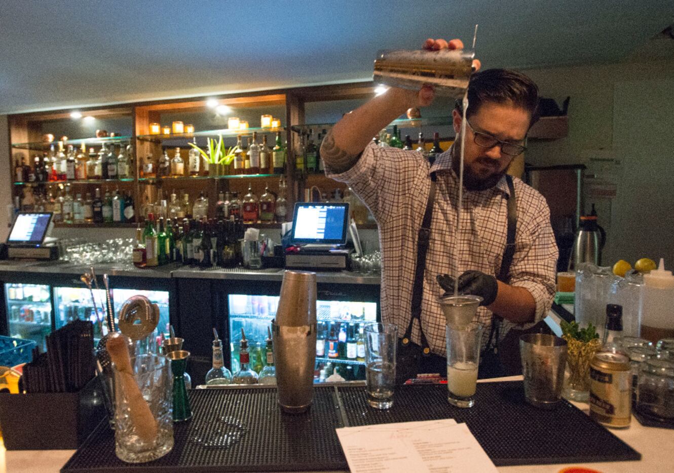 Lounge Here bartender Brad Bowden prepares a drink on 12/11/16 in Dallas, Texas. 