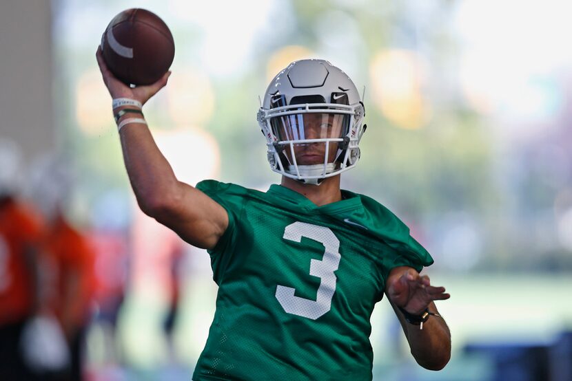 Oklahoma State quarterback Dru Brown throws during an NCAA college football practice in...