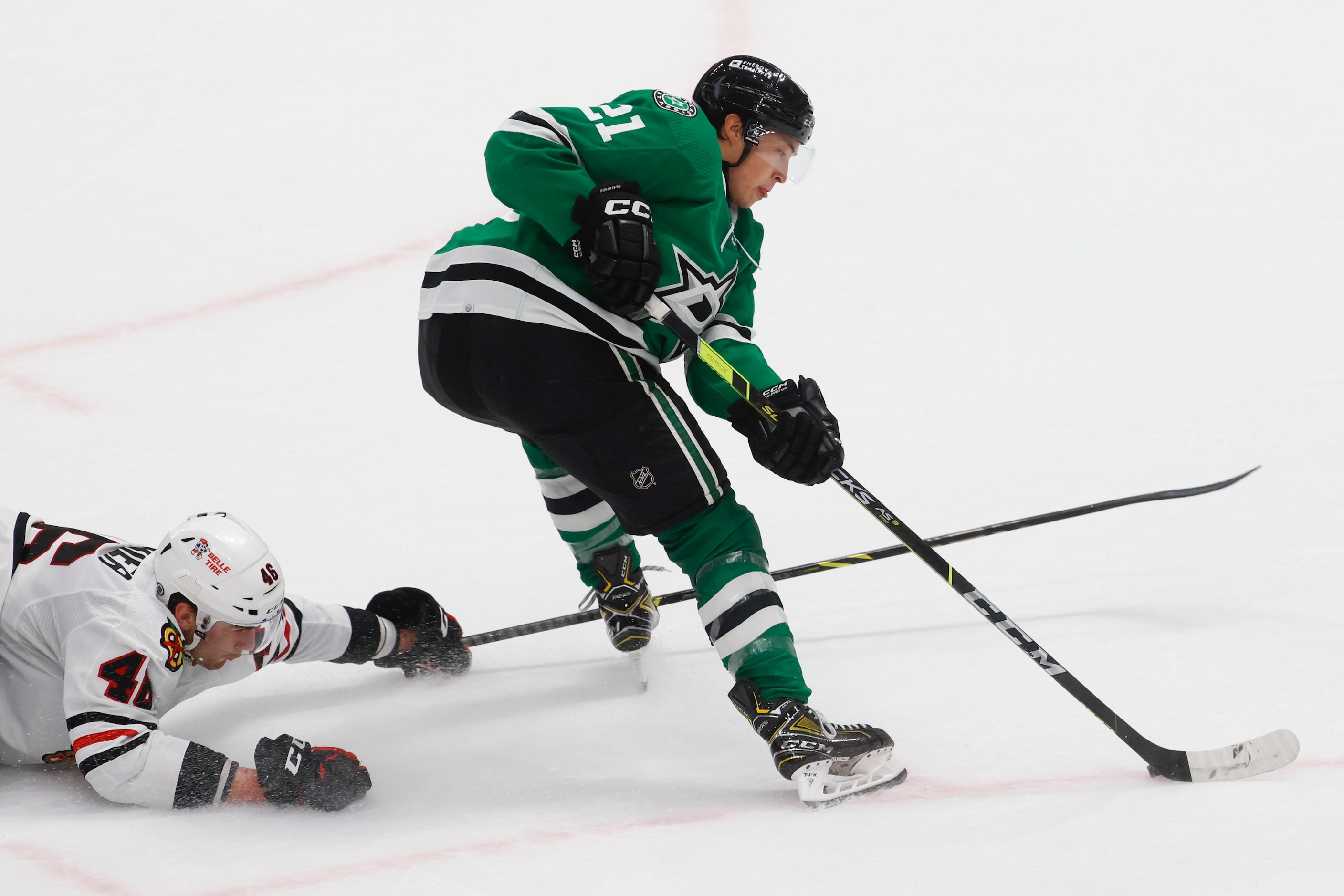 Chicago Blackhawks defensemen Louis Crevier tries to stop Dallas Stars left wing Jason...