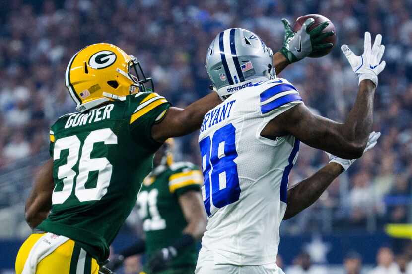 Dallas Cowboys wide receiver Dez Bryant (88) has a pass blocked by Green Bay Packers...