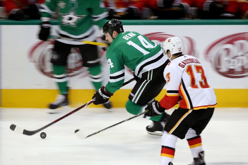 Dallas Stars left wing Jamie Benn (14) moves the puck against Calgary Flames left wing...