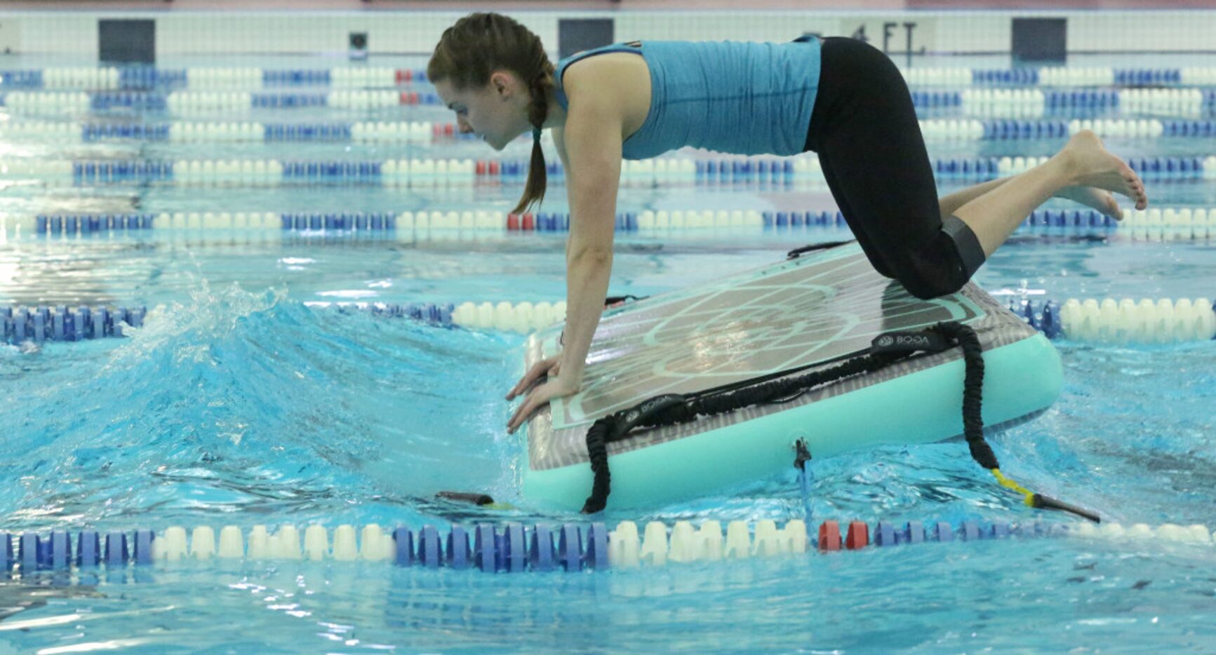 Jill Nicholas balances on her board during "floating workouts," which are fitness classes...