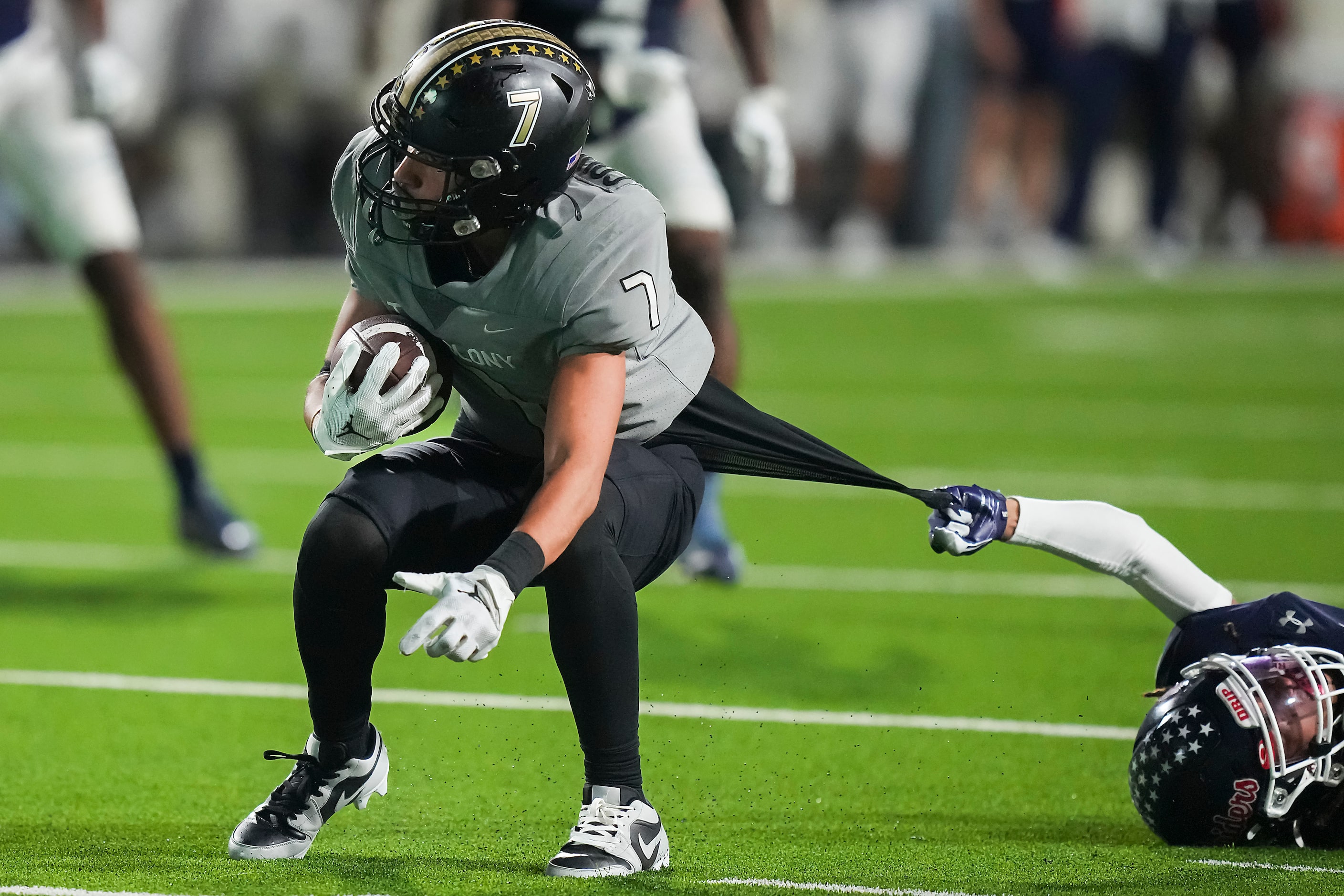 The Colony wide receiver Carmelo Torres (7) slips away from Denton Ryan defensive back...