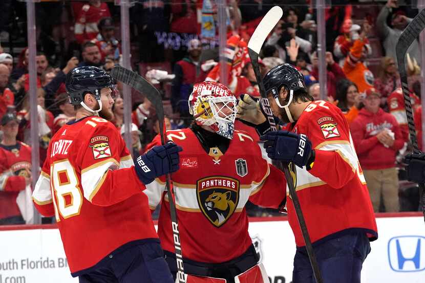 Florida Panthers goaltender Sergei Bobrovsky, center, is congratulated by center Steven...