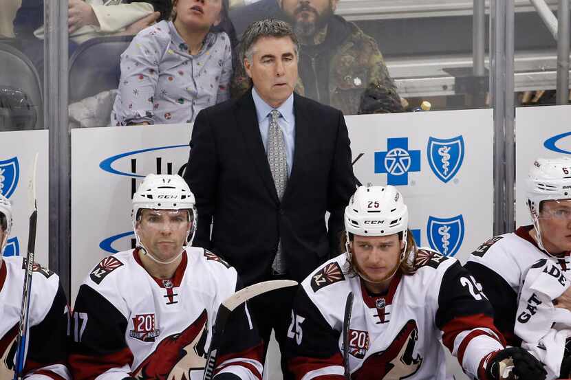 FILE - In this Dec. 12, 2016, file photo, Arizona Coyotes coach Dave Tippett stands behind...
