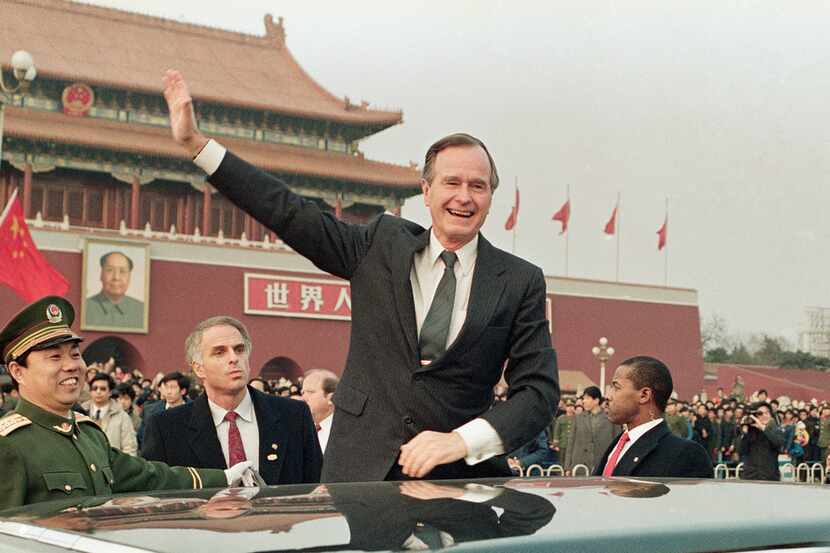 In this Feb. 25, 1989, file photo, then U.S. President  George H.W. Bush stands on his car...